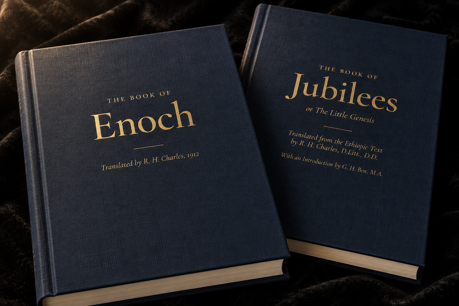 The Book of Enoch and The Book of Jubilees side by side, both in navy cloth with gilt-stamped titles, bound to match.
